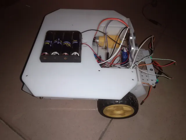 Robot chassis from above, showing motor driver and battery pack