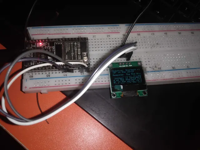 ESP32 microcontroller wired to an OLED display on a breadboard