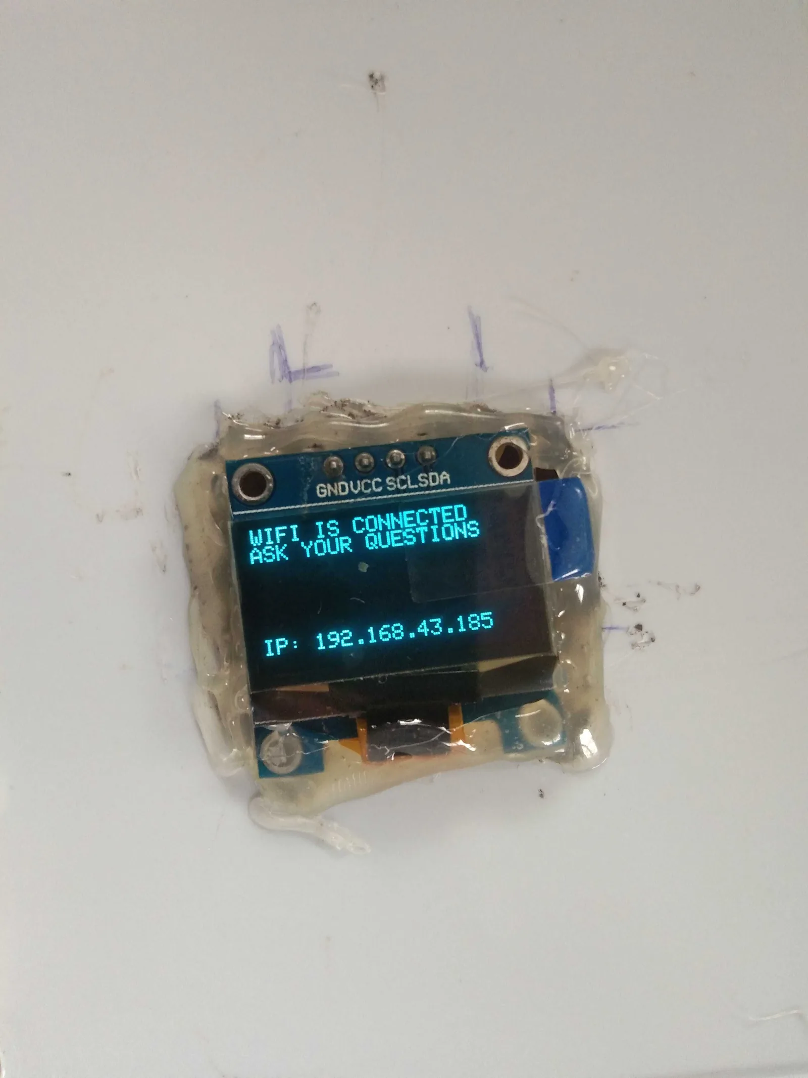 OLED display reading WIFI IS CONNECTED, ASK YOUR QUESTIONS, with a local IP address